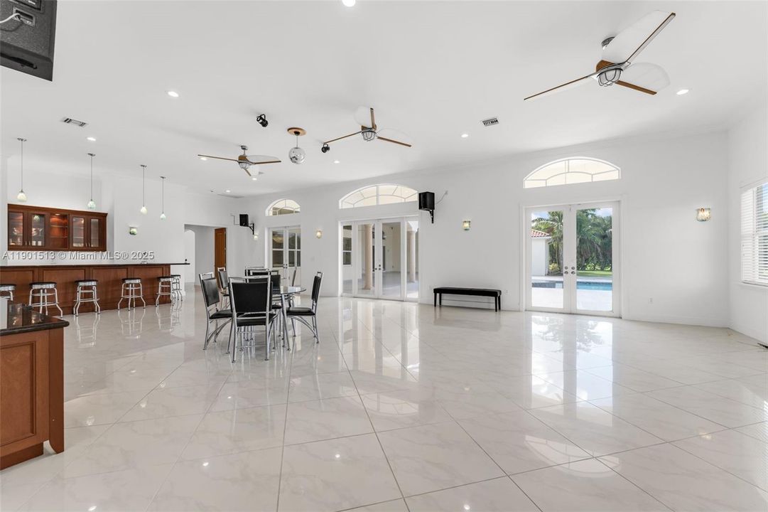 MEDIA ROOM W/ FULL SERVICE 10 TOP WET BAR, SOUND SYSTEM, WIFI, ADJACENT STORAGE OR PREP STATION, GOTTA LOVE THE DISCO BALL W/ DOORS LEADING TO THE COVERED TERRACE OVERLOOKING POOL & SPA. THERE IS A SIDE ENTRANCE TO BYPASS LIVING AREAS ON THIS ESTATE.