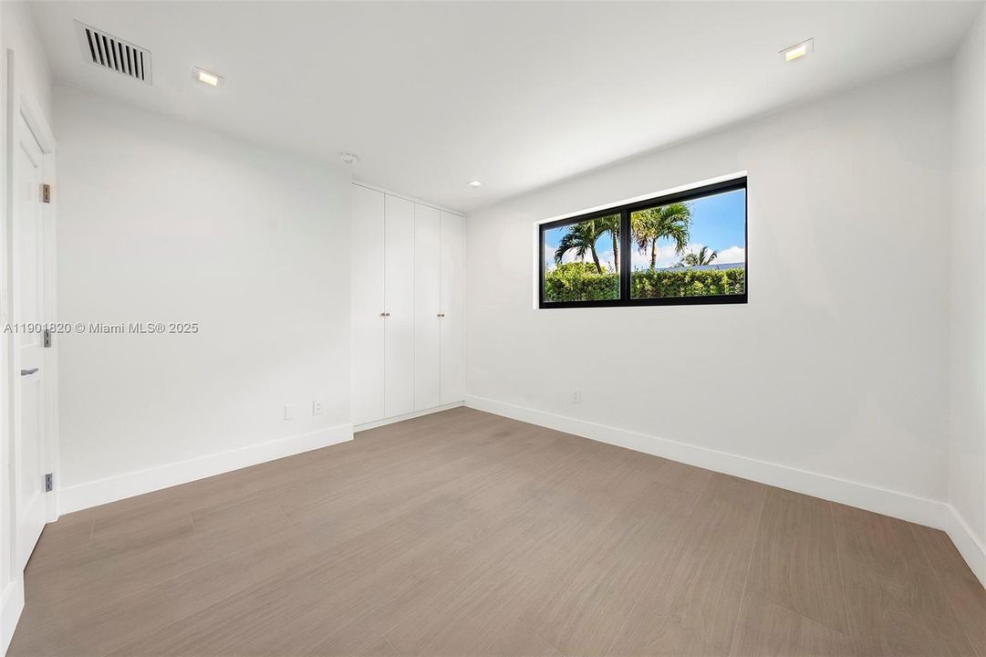 Fourth Bedroom with custom made closets.