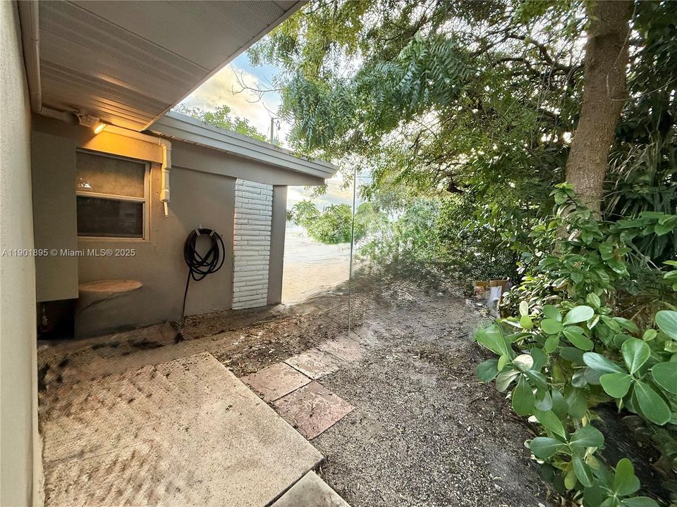 Front of home with entrance to side to access backyard.