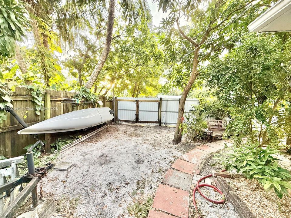 Front of house Side yard with a double wide gate large enough to pull in your RV, boat, trucks, etc with 40 feet of parking available