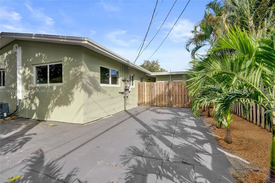 Unit 2 - Private fully enclosed large wrap around back yard. South side of unit. Fence along the palm trees are being replaced by neighbor.