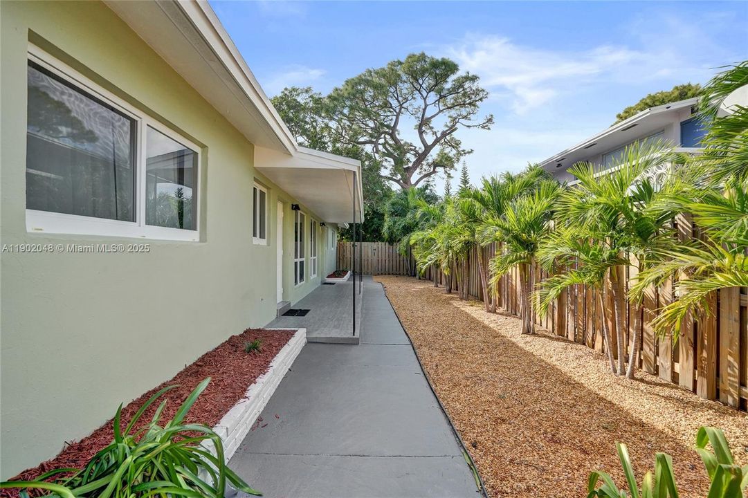 Front entrances of residences. Behind you are the exterior and parking.