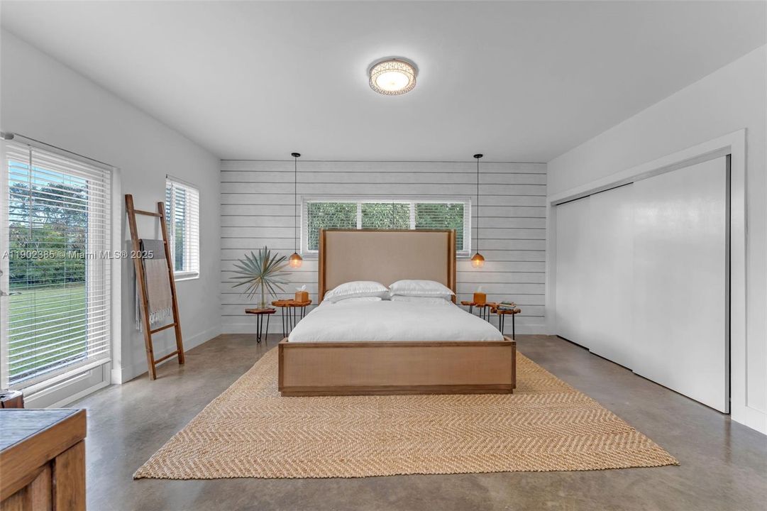 LARGE PRIMARY WING OF THE HOME, WITH IMPACT DOORS LEADING TO THE PROPERTY, BEAUTIFULLY COORDINATED ORGANIC FIXTURING & POLISHED FLOORS, ALSO A LARGE SITTING AREA/OFFICE OFF THE SUITE.