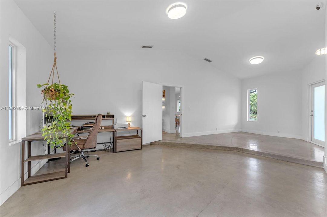 OPEN FOYER AREA W/ OFFICE NOOK AND FRENCH DOORS LEADING TO THE BACK OF THE PROPERTY & IMPACT GLASS FRONT DOOR. THIS LEADS TO THE LIVING AREAS & THE BEDROOMS