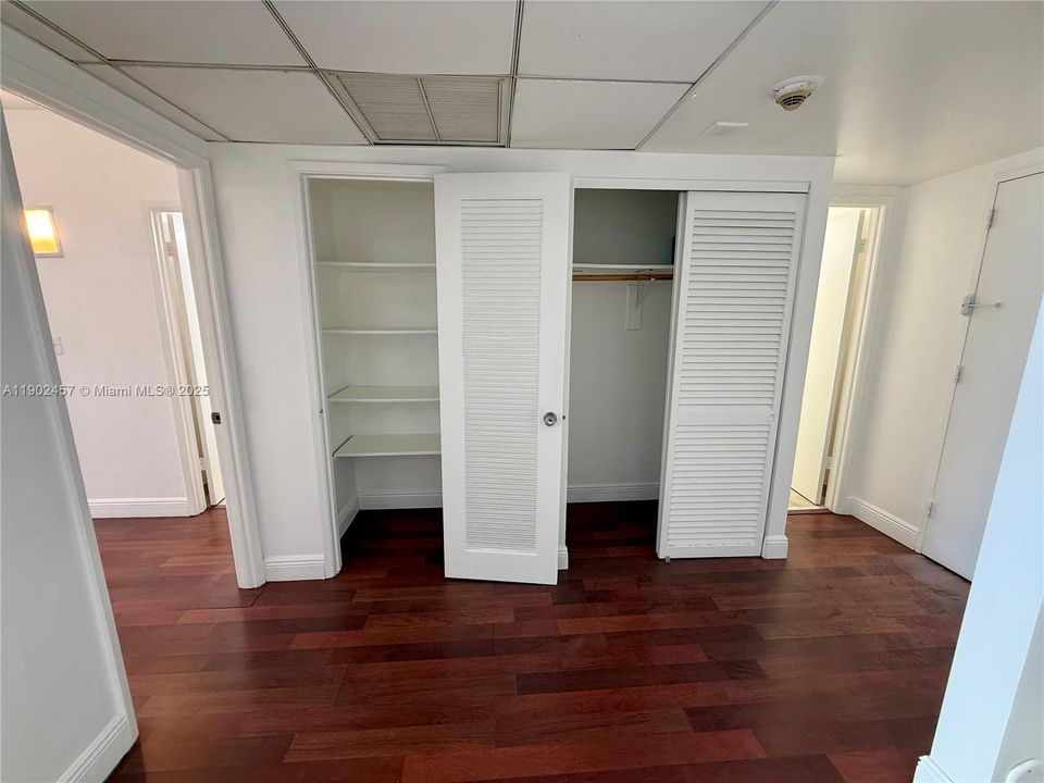 Bedroom entrance on left, pantry and closet, half bathroom and apartment entrance on right.
