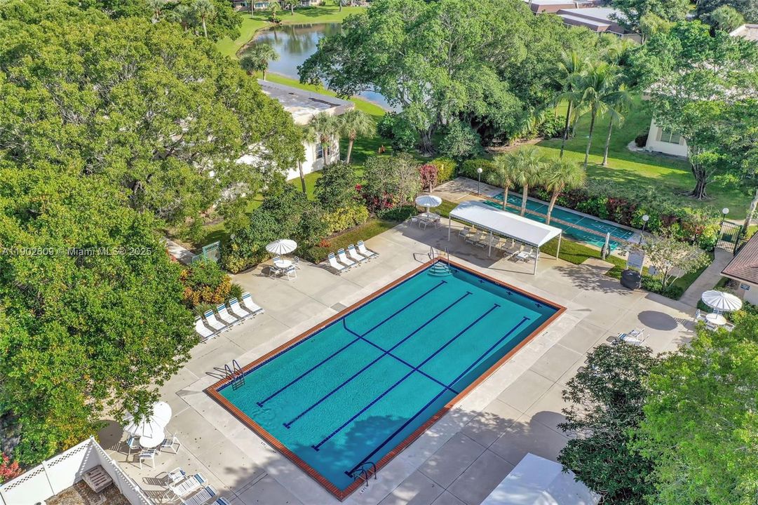 Resort-style amenities include a sparkling lap pool with plenty of lounge space, shaded seating areas, and beautifully landscaped surroundings — perfect for a morning swim or an afternoon in the sun.