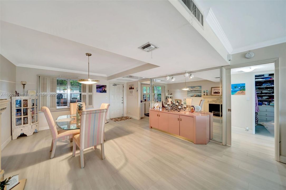 The open-concept dining and living space features neutral flooring, crown molding, and great natural light. There’s plenty of room for both casual gathering and formal dining, plus flexible layout options to fit your lifestyle.