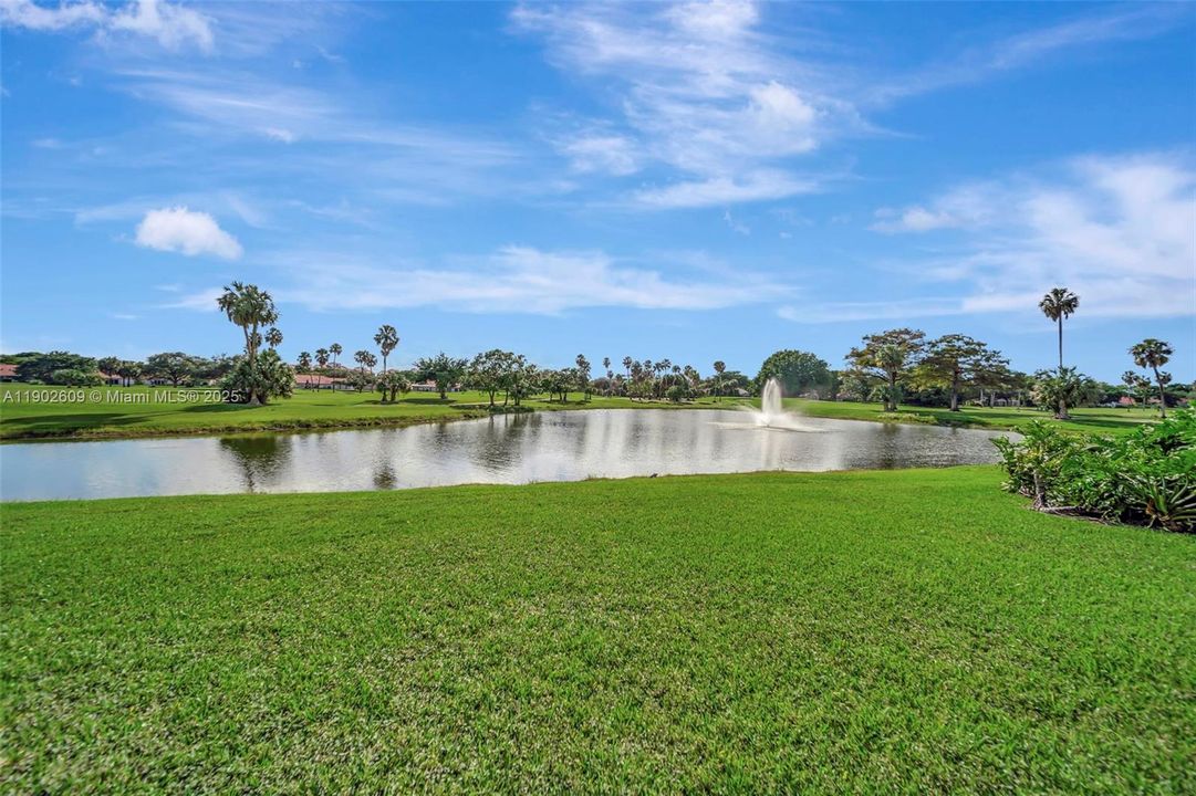 Serene lake and golf course views with a peaceful fountain backdrop — the perfect daily outlook from this community.