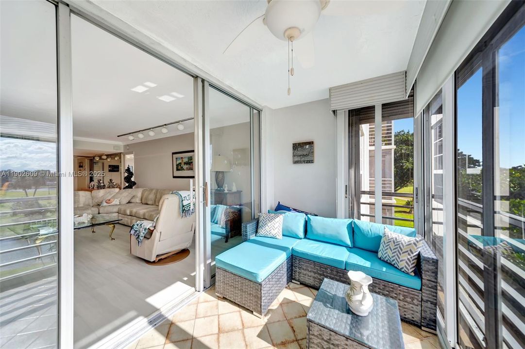 Step into the enclosed Florida room and unwind — surrounded by sliding glass doors, this indoor/outdoor lounge extends your living space and captures tranquil water and golf course views.
