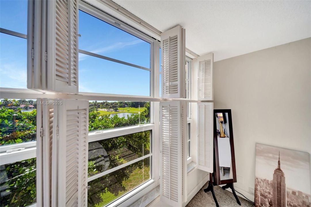 Wake up to sweeping golf and water views. The primary bedroom is wrapped in classic plantation shutters that open wide for gorgeous natural light and lush, green scenery — a calm, private outlook you don’t usually get in a condo.
