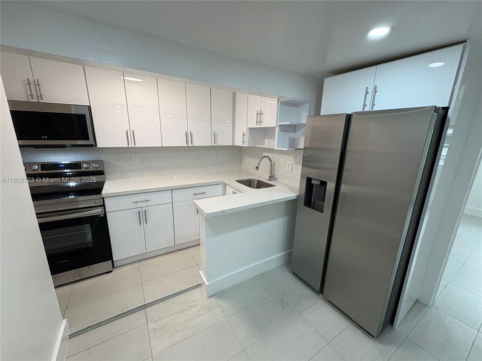 Remodeled kitchen w/ stainless steel appliances.