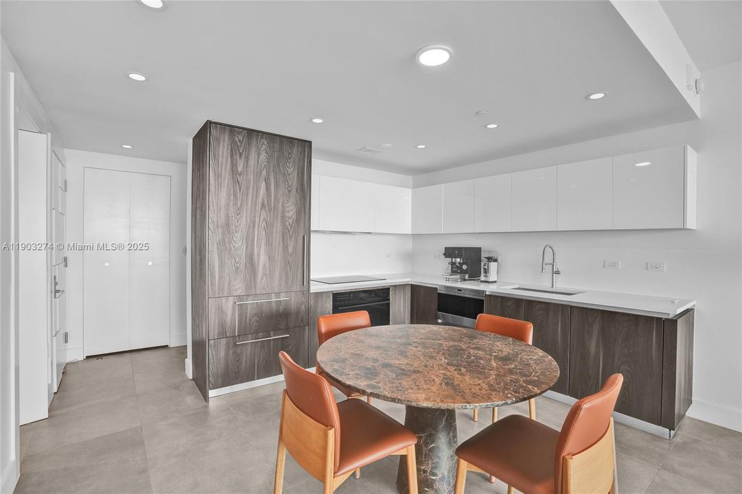 Upper kitchen cabinets have been refinished in Italkraft white high gloss