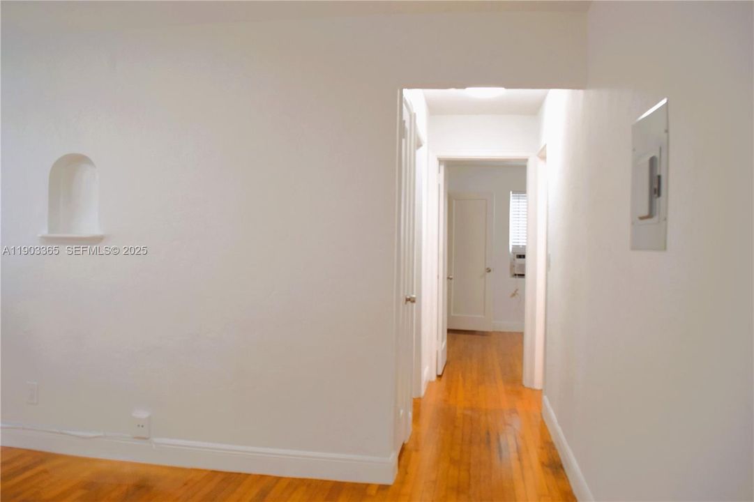 Hallway. 2 bedrooms. Beautiful wood floors throughout.