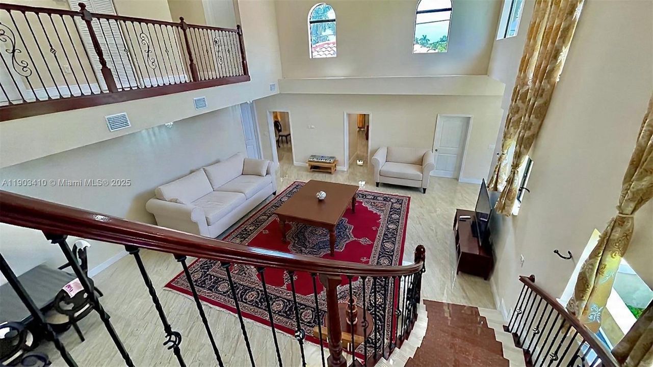 View to the living/dinning from the stairs balcony (digitally staged)