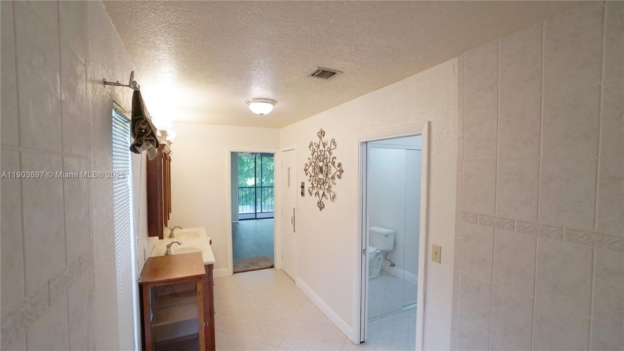 The master bath continues to separate shower and toilet.