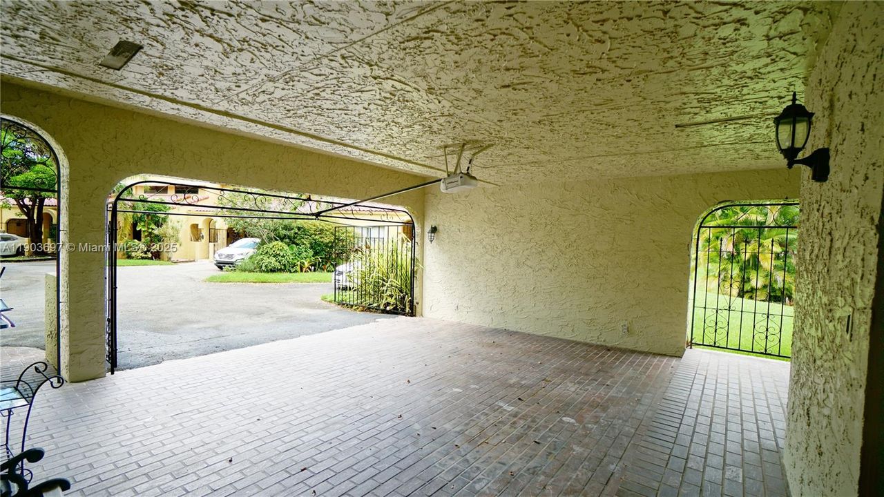Spacious carport. Ample parking, room for a golf cart. Automatic gate.