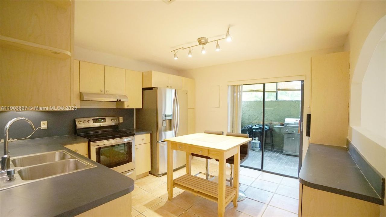 Charming kitchen opens to the barbecue patio.