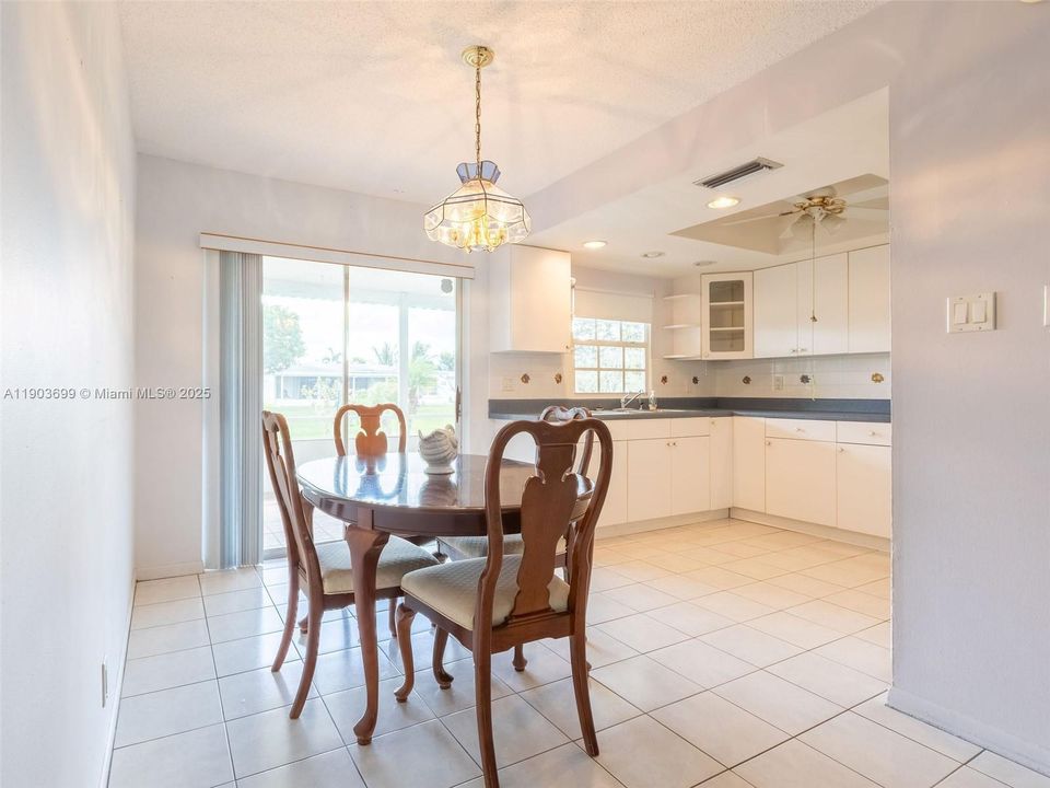 Dining room overlooking the screened patio , with lovely water views!