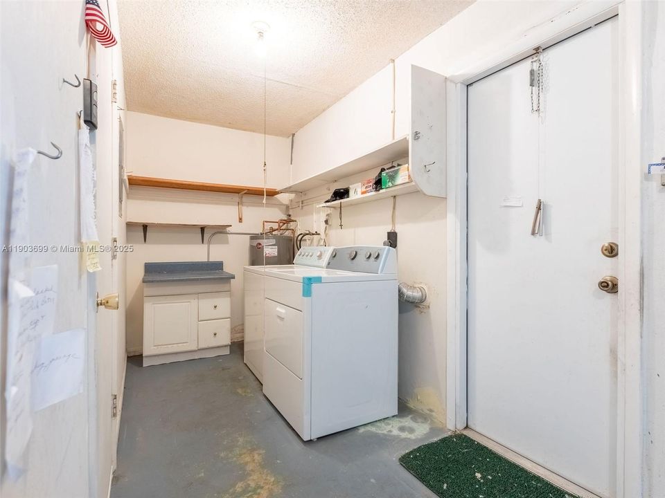 Laundry room in the garage,  adjacent to kitchen