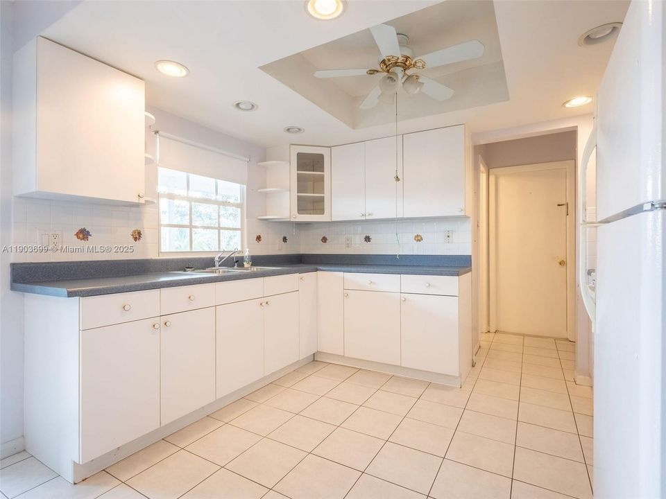 Plenty of storage in this kitchen, overlooking the covered patio and canal!