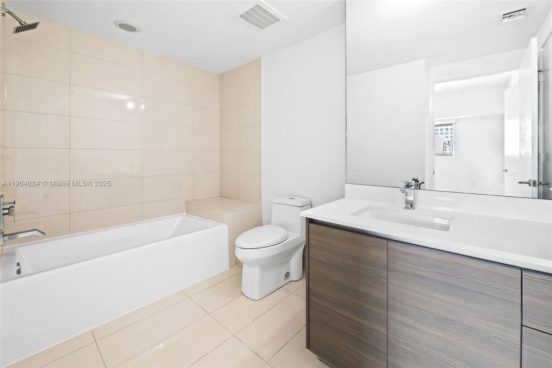 Modern additional bathroom with tub