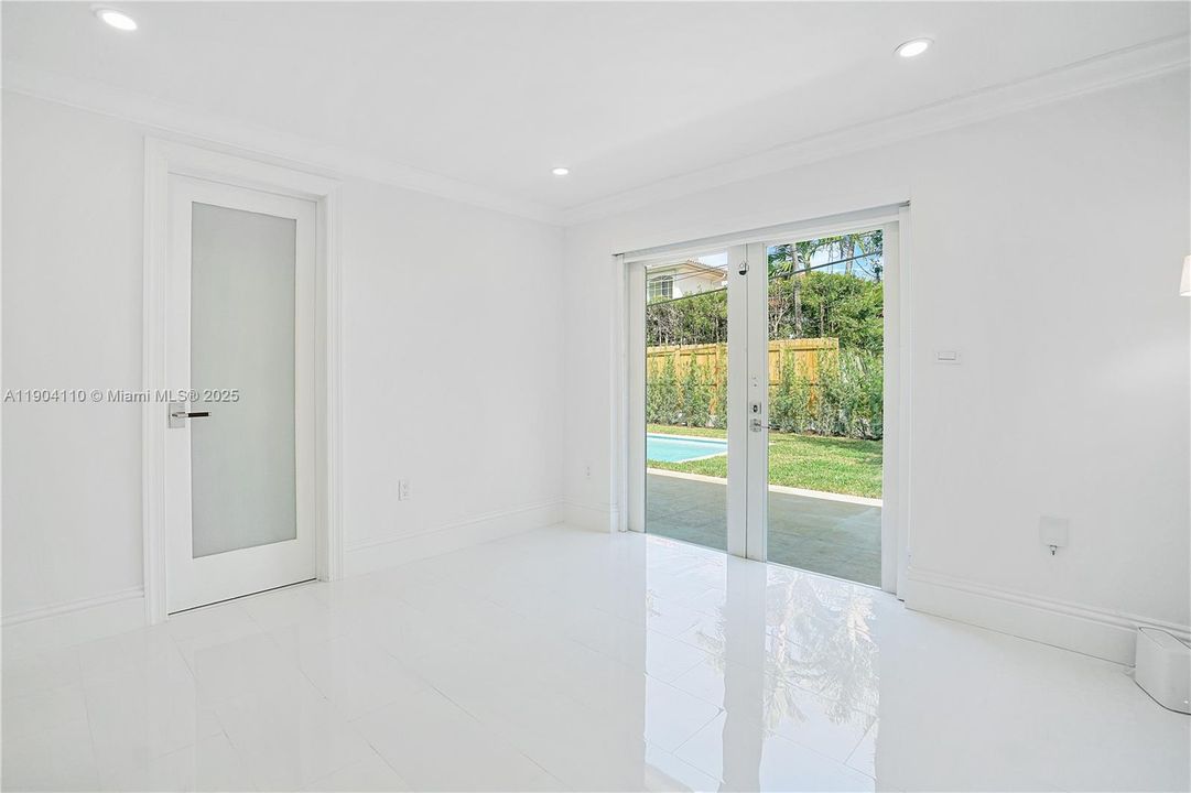 Primary Bedroom with French Doors to Backyard Garden and Pool Deck