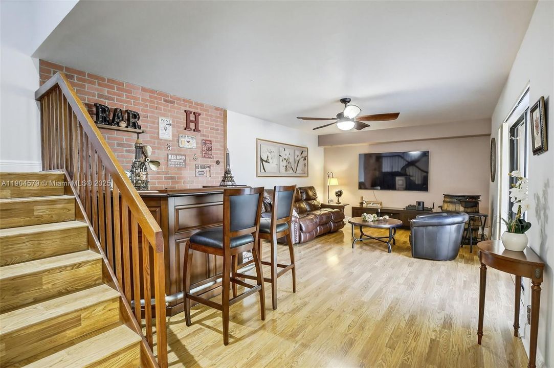 Staircase w/ storage closet below, leading to the upstairs bedroom quarters & two full bathrooms.
