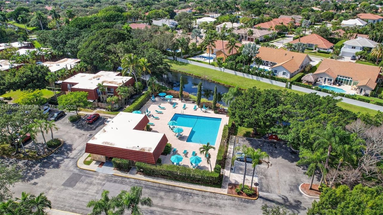 Relaxing heated community pool and sundeck overlooking a tranquil lake.