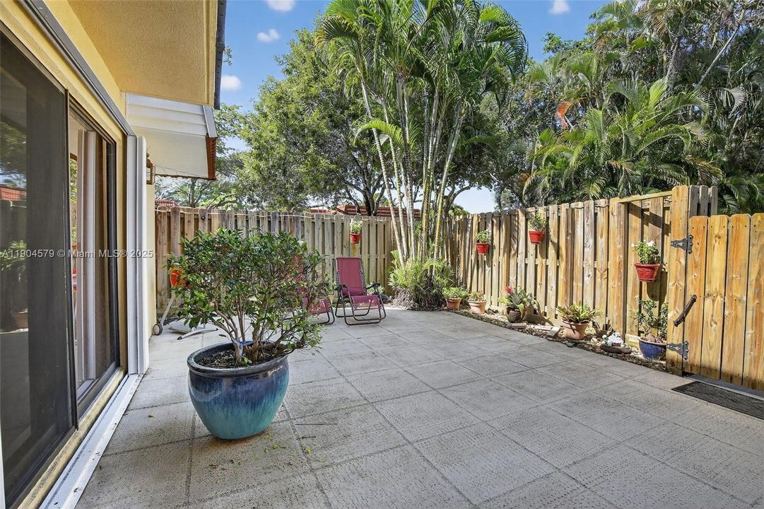 Private fenced-in courtyard perfect for entertaining, relaxing, or BBQs with friends and family. Accordion shutters on windows.