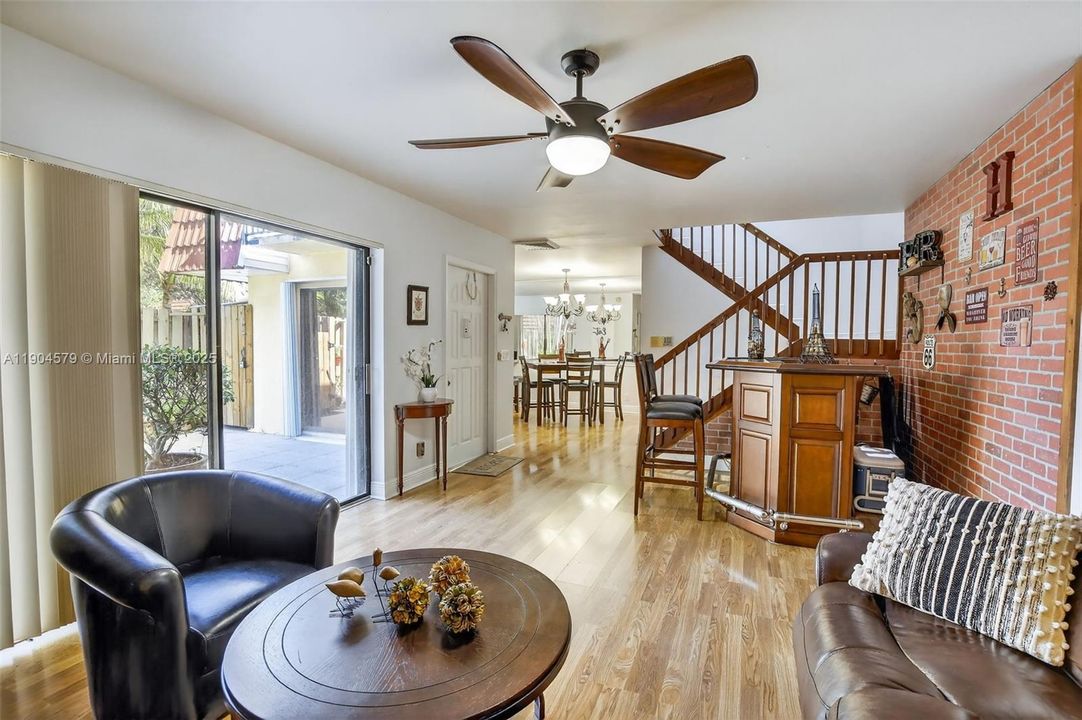 Bright open-concept living area filled with natural light and stylish laminate flooring & no popcorn ceiling.