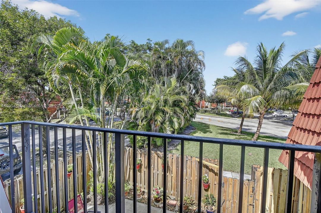 Dual private balconies overlooking the peaceful community greenery.