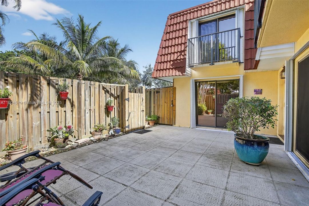 Private fenced-in courtyard perfect for entertaining, relaxing, or BBQs with friends and family. Accordion shutters on windows.