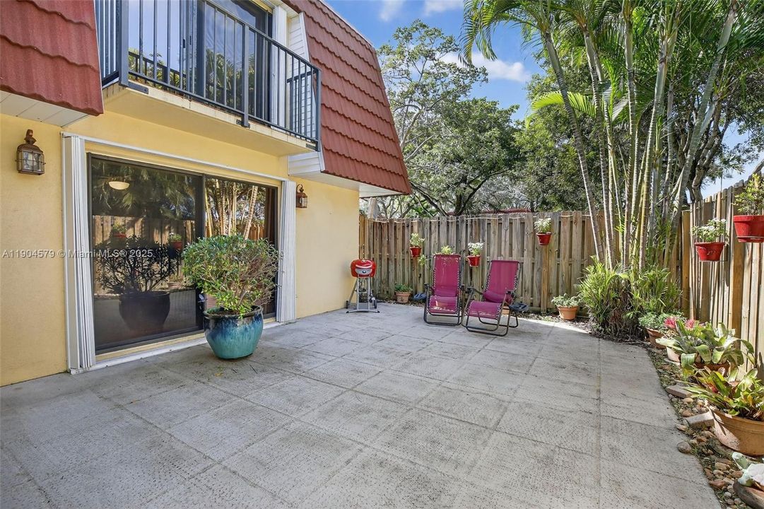 Private fenced-in courtyard perfect for entertaining, relaxing, or BBQs with friends and family. Accordion shutters on windows.