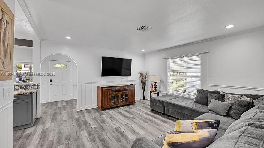 Arched Walkways, Baseboards Wall, Crown Molding, Drywall, Natural Light, Paneling Wall, Recessed Lighting, Textured Ceiling, U Shaped Kitchen, Vent, Wainscot Wall, Wood Finish Floor, Crown Molding, Wainscot Wall, Wood Finish Floor