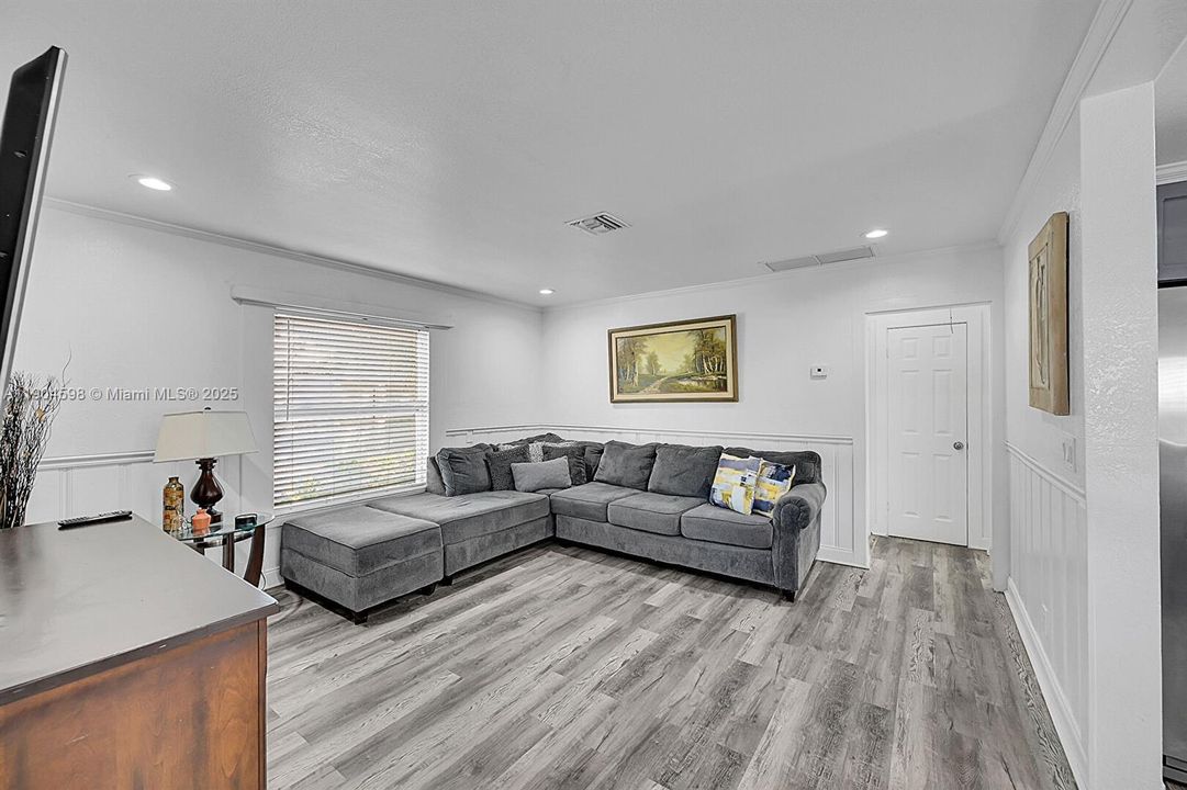 Arched Walkways, Baseboards Wall, Crown Molding, Drywall, Natural Light, Paneling Wall, Recessed Lighting, Textured Ceiling, U Shaped Kitchen, Vent, Wainscot Wall, Wood Finish Floor, Crown Molding, Wainscot Wall, Wood Finish Floor