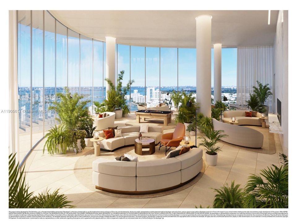 Elegant Canopy Club lounge at Five Park Miami Beach featuring floor-to-ceiling glass, panoramic bay views, and modern designer interiors for exclusive residents.