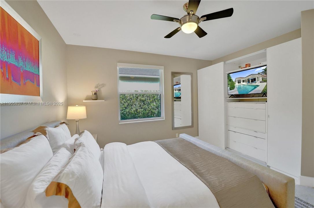 Bedroom 2 with TV in custom closet