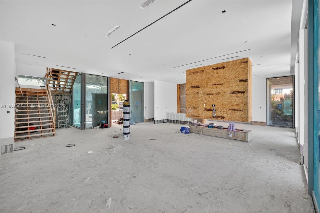 Actual photo as of Oct 31, 2025. Floating fireplace to separate the living room from family room. Stairs will be floating stairs.