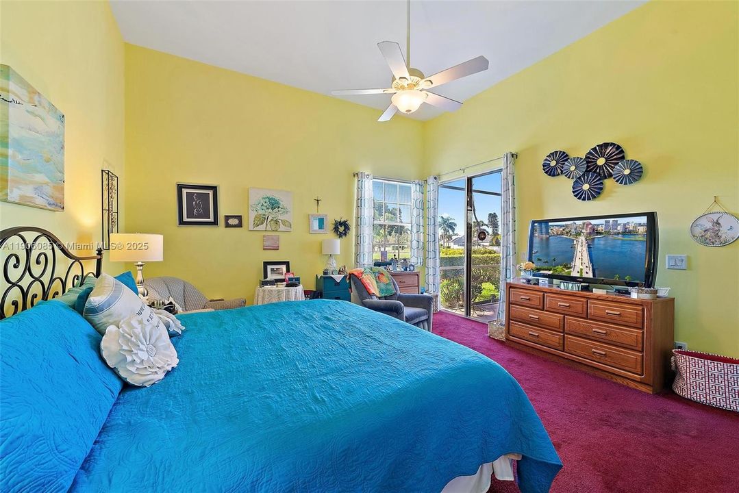 Primary Bedroom with ensuite bathroom and walk in closet. Sliders doors to screened in porch.
