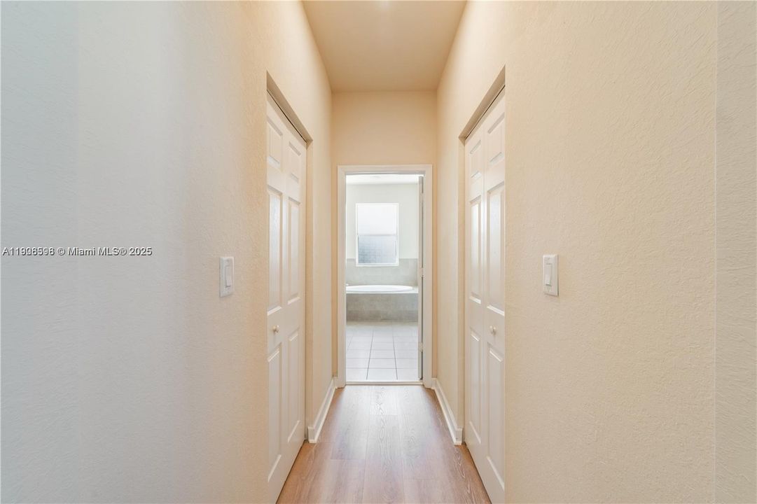 His/her closets with entry to bathroom