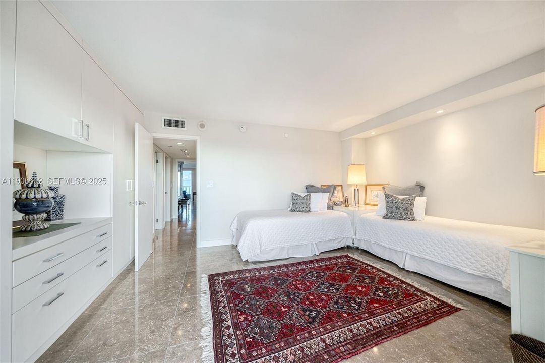 Bedroom 2 with 2 twin beds and custom closets.