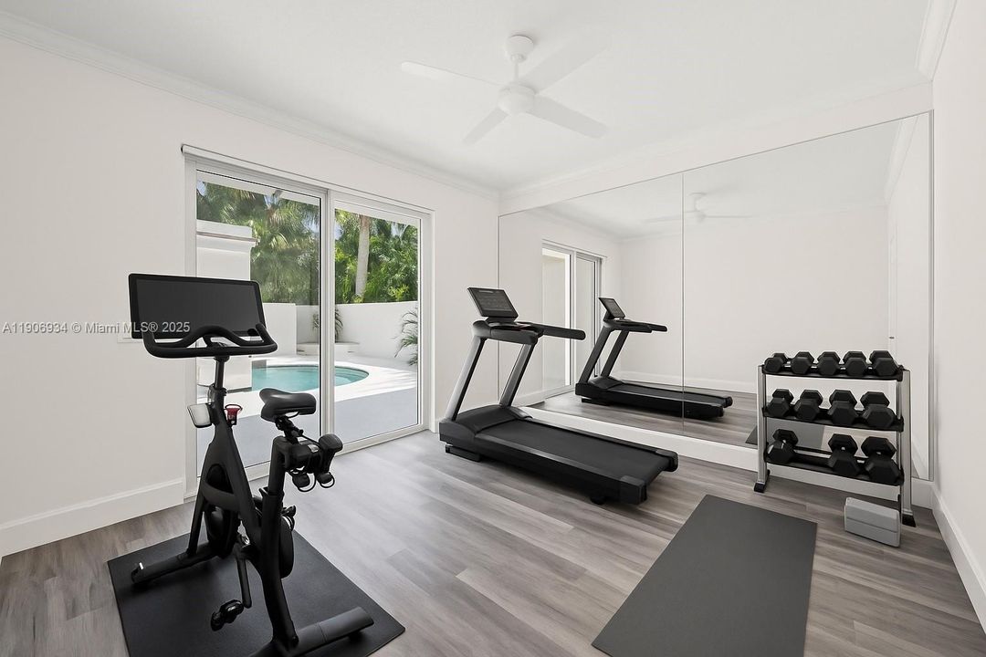 Virtually staged home gym off courtyard/pool.