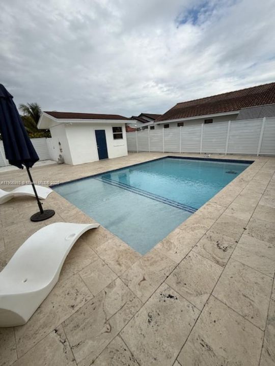 Pool and beach area view with side additional storage or cabana bldg.