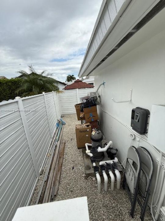 Pool equipment area behind storage bldg
