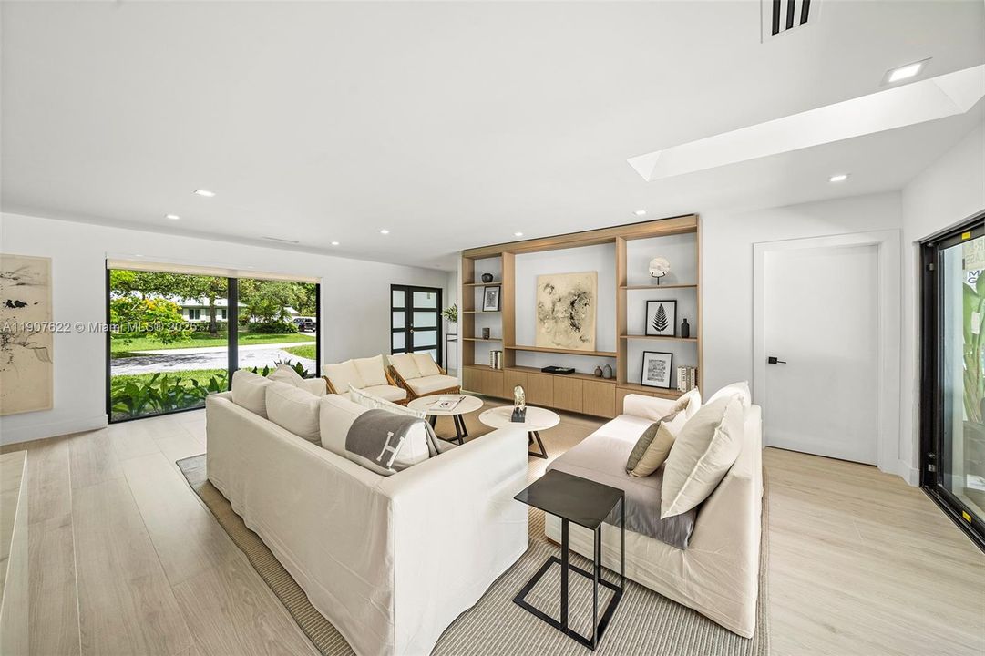 Flooded with natural light thanks to oversized impact windows that connect every space to the lush outdoors.