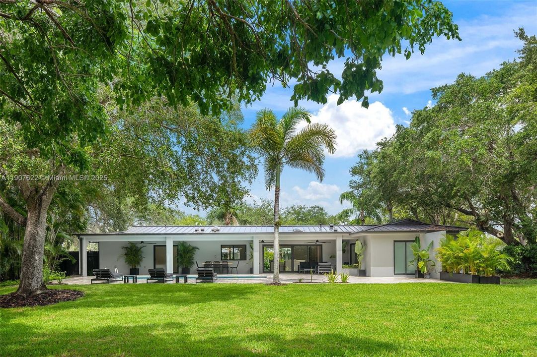 Fully rebuilt with exquisite taste, 5BR/4.5BA, rare 21,875sf lot, lush privacy, high-end finishes, covered terrace, pool, and 1-car garage.