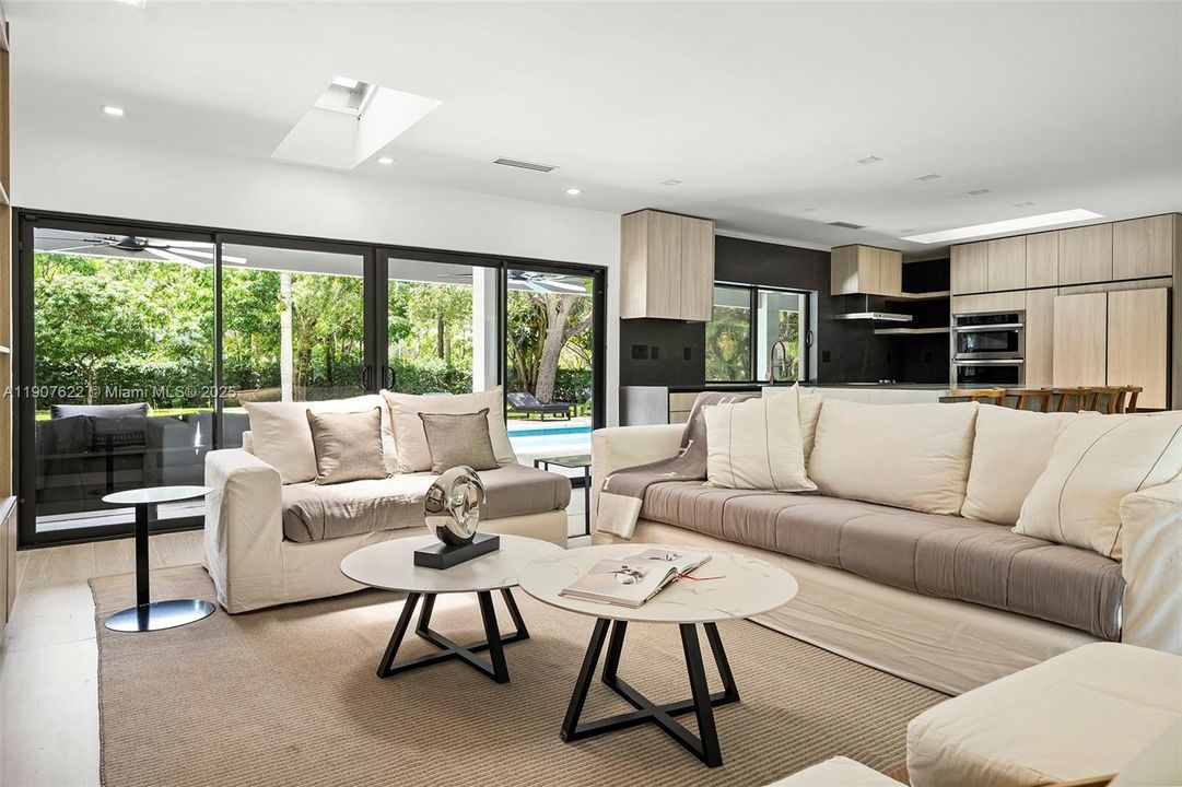 Enjoy spectacular views of the lush, private backyard—seamlessly visible through expansive glass doors that flood the space with natural light.