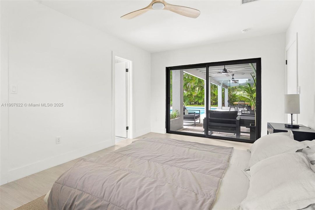 Second bedroom suite offers direct access to the covered terrace and pool area—blending indoor comfort with seamless outdoor living.