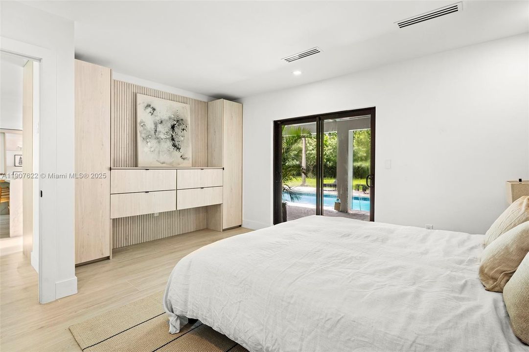 Master Bedroom features a custom built-in dresser wall—designed with natural textures and clean lines