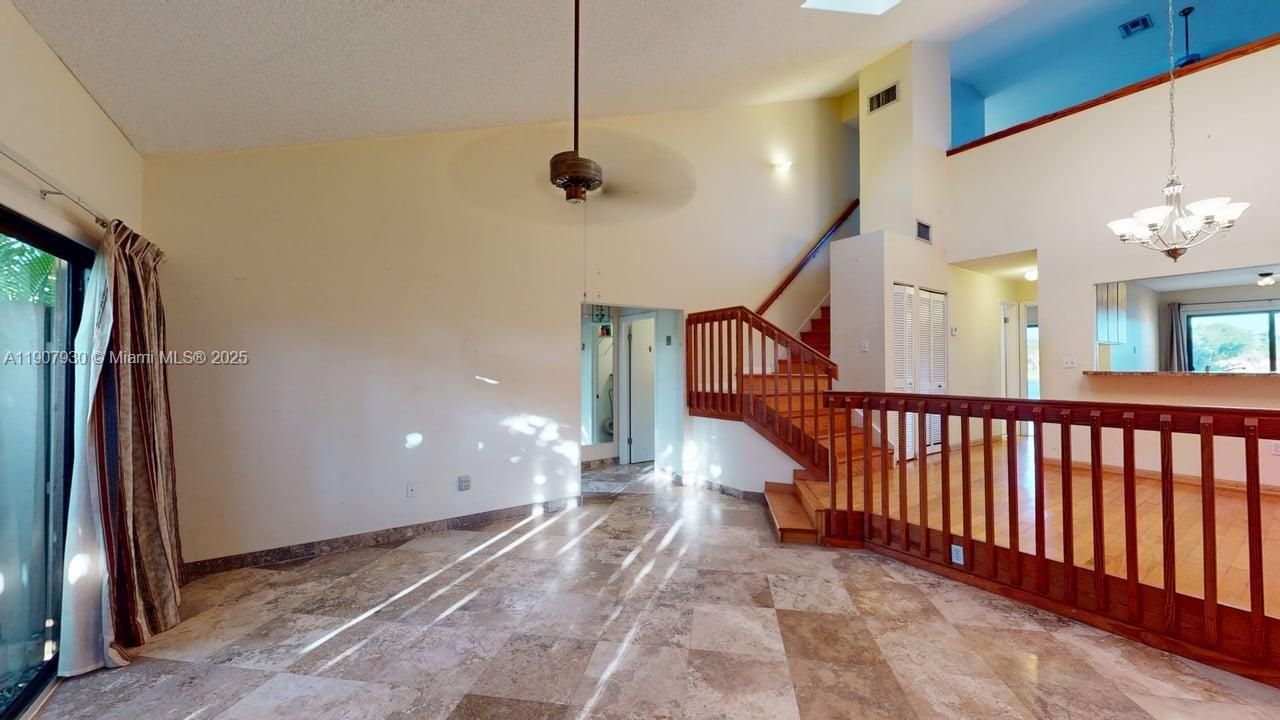 Spacious open living area with high-end polished travertine floors and stunning natural light that highlights every detail.